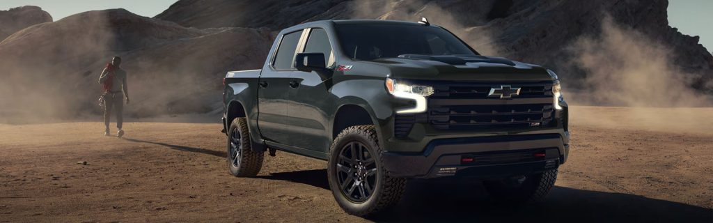 2026 Chevrolet Silverado Z71 off-roading in a rugged landscape.
