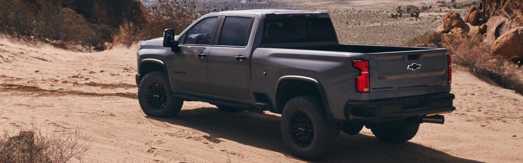 Chevrolet Silverado ZR2 off-roading in desert terrain.