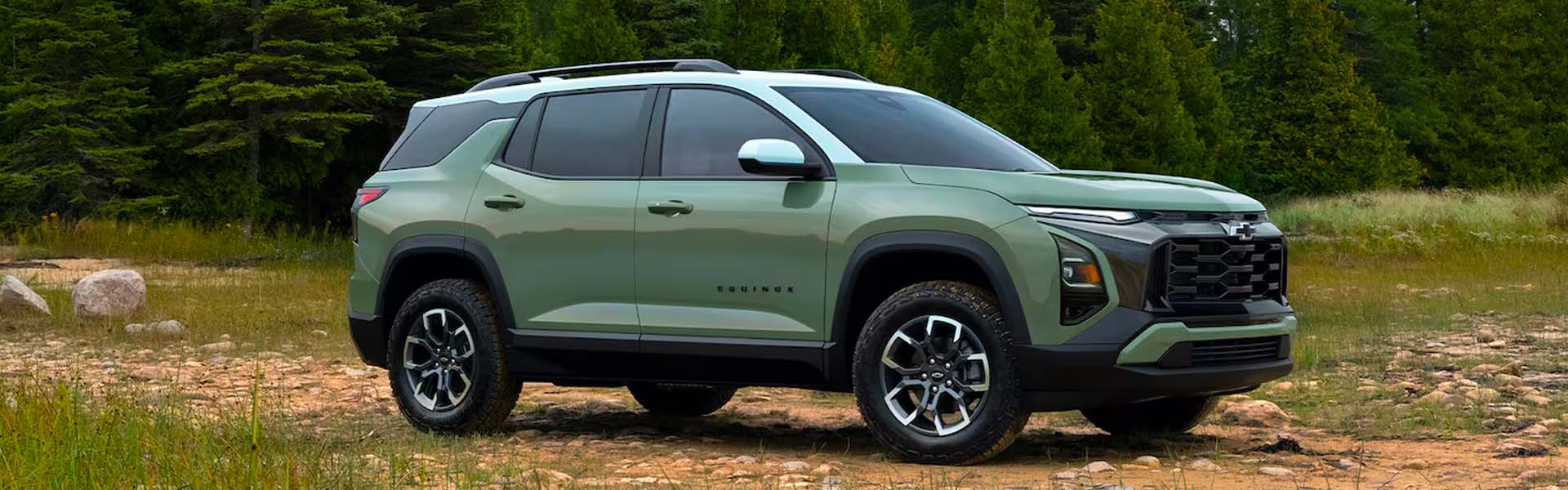 Green Chevrolet Equinox SUV on an outdoor trail.
